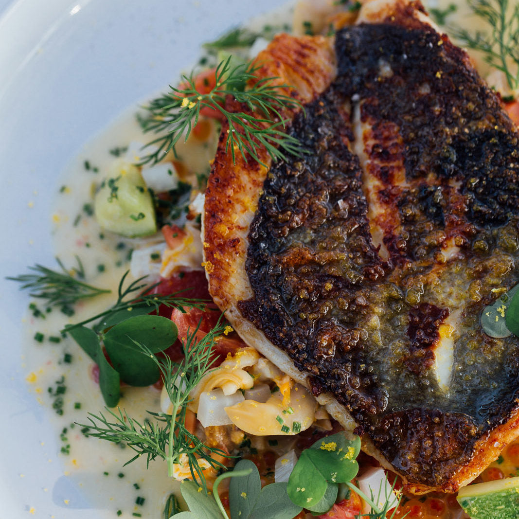 Barbequed John Dory with warm salad of diamond clams, zucchini and Smoked Salmon Pearls